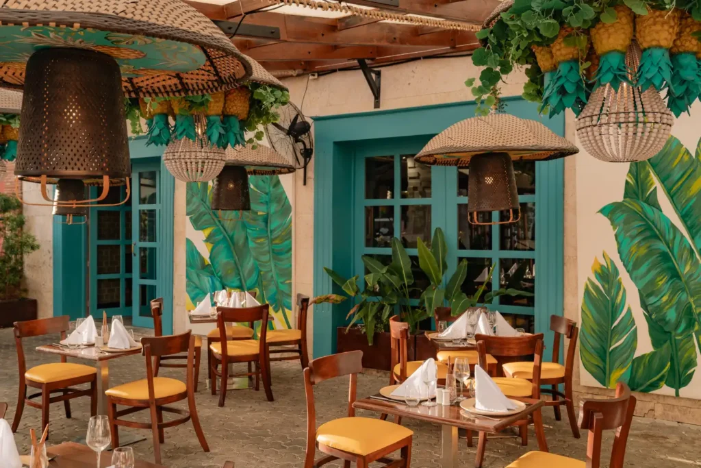 a restaurant with tables and chairs and a mural on the wall