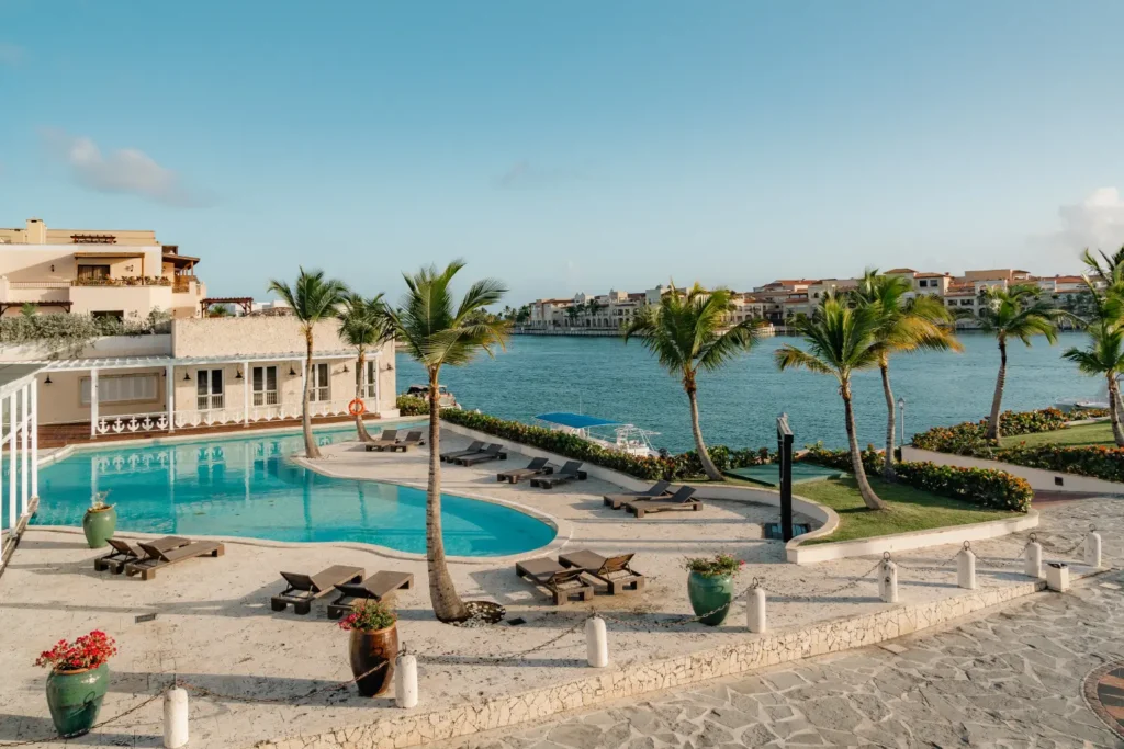 a resort with a swimming pool surrounded by palm trees