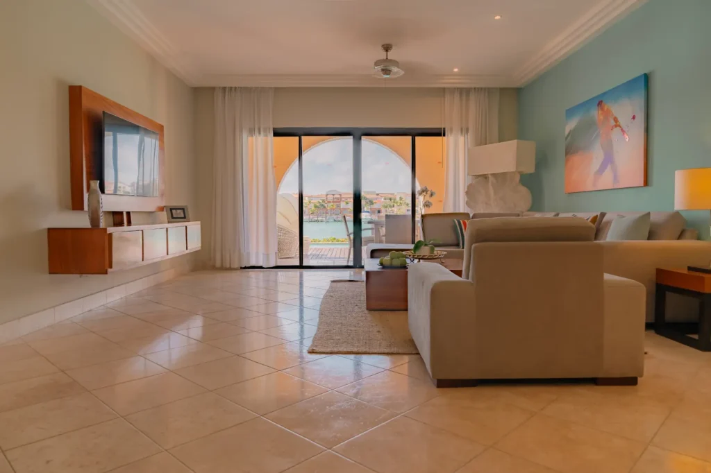 a living room filled with furniture and a sliding glass door