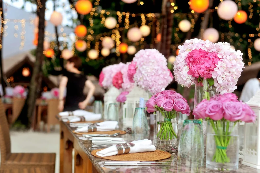 a table topped with vases filled with pink flowers