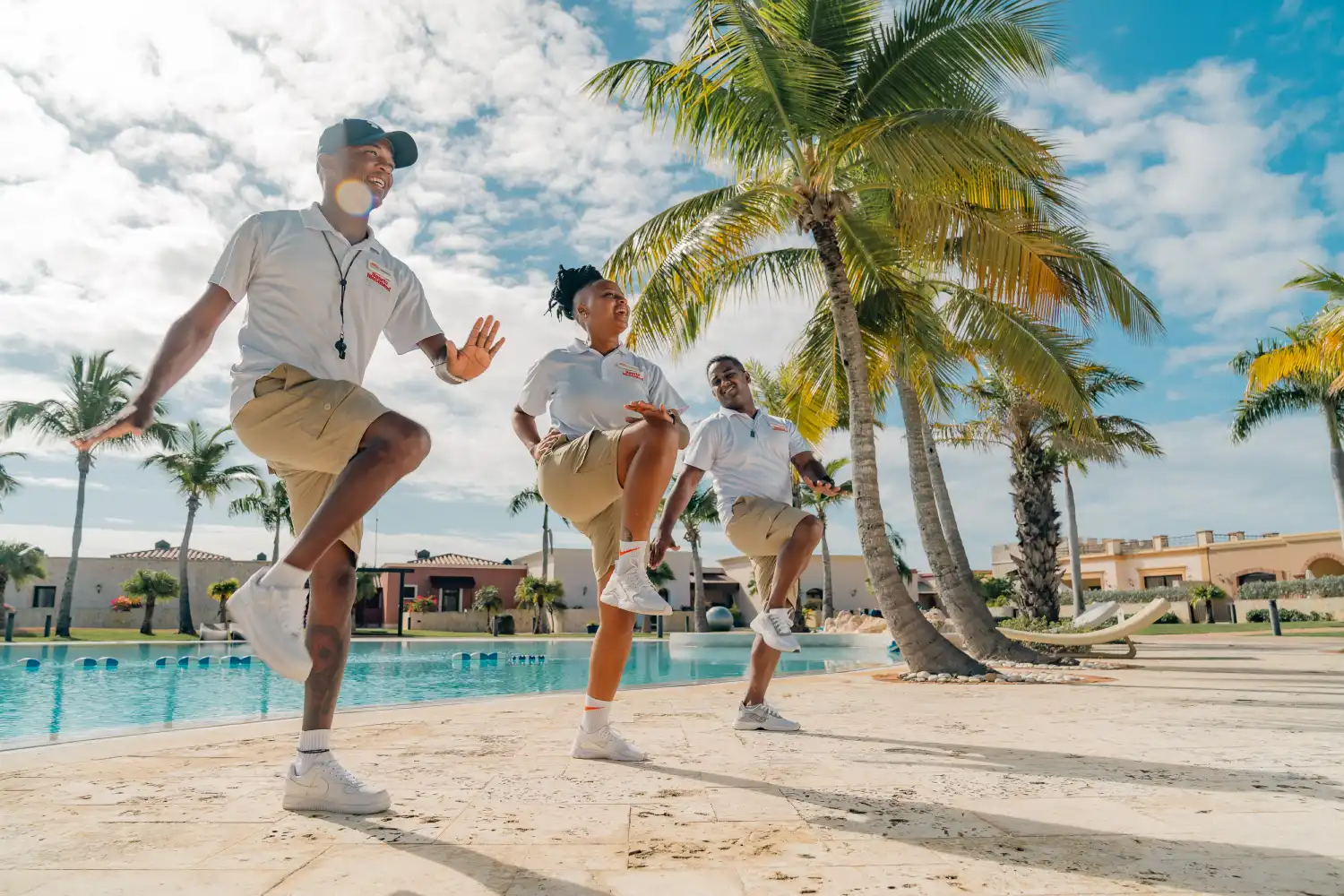 a group of people that are standing in the sand