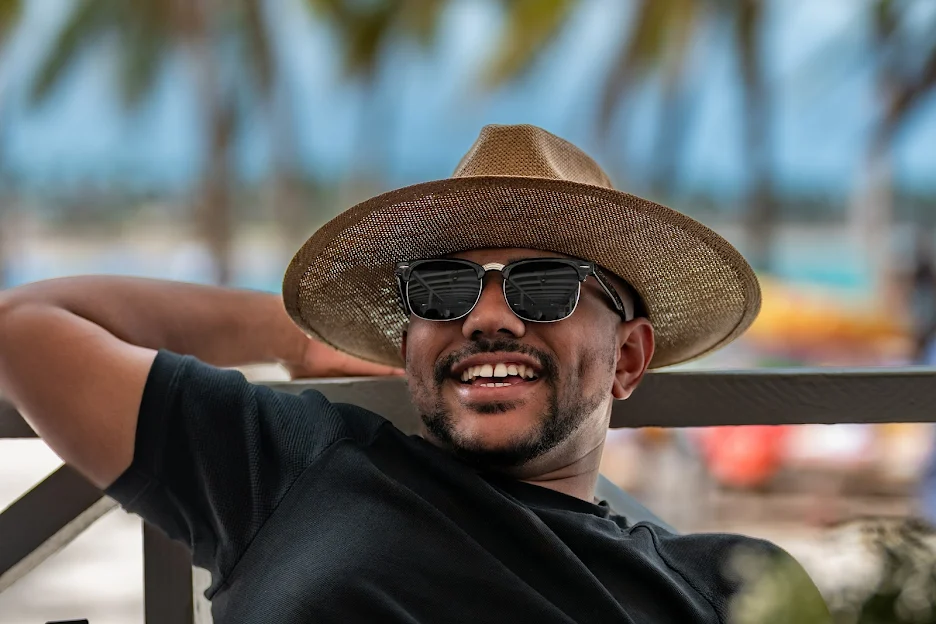 a man wearing a straw hat and sunglasses