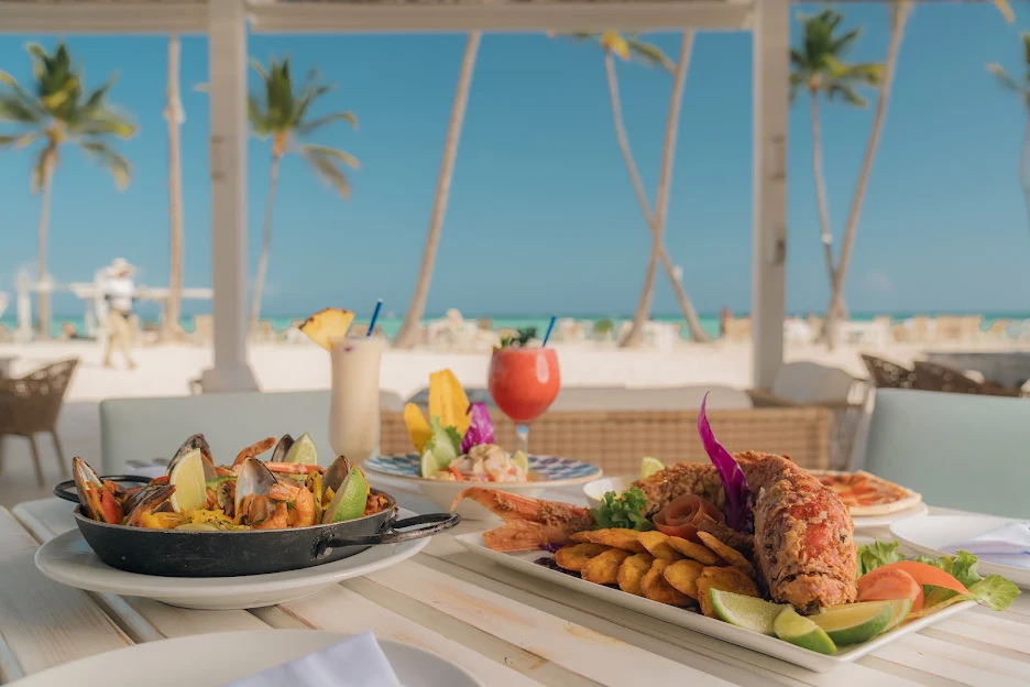 a table with plates of food and drinks on it