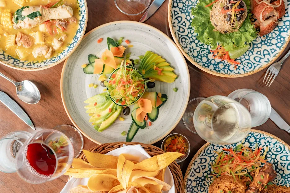 a table topped with plates of food and glasses of wine