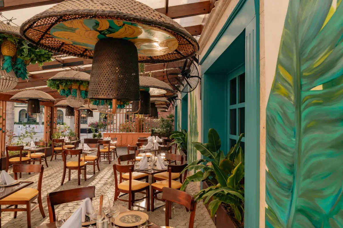 a restaurant with tables, chairs, and umbrellas