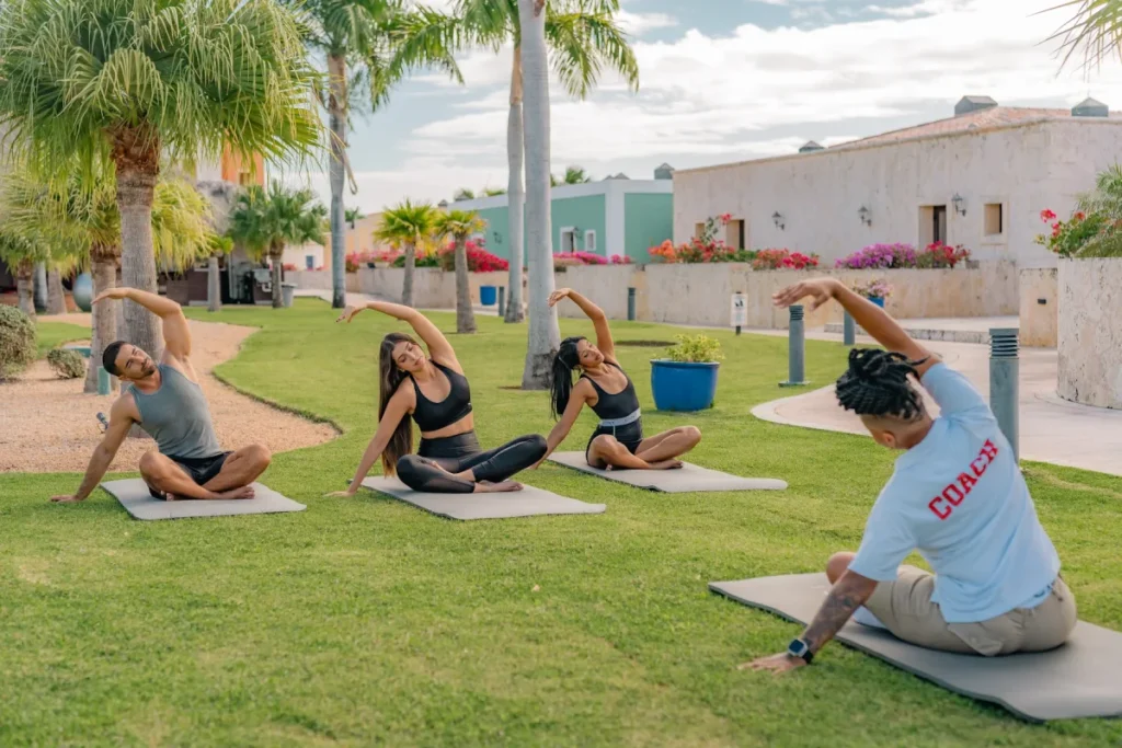 a group of people doing yoga in a park